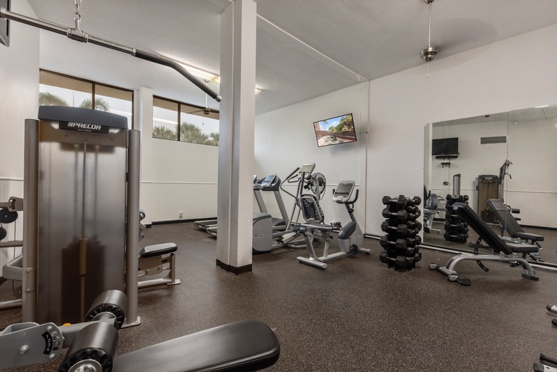 Your fitness goals await in this well-equipped gym, complete with modern cardio machines, free weights, and strength training equipment for your daily workout.