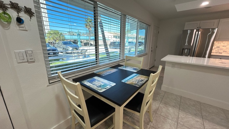 Your bright dining nook offers the perfect spot for morning coffee and planning adventures, with natural light streaming through the blinds.