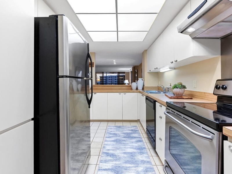 Step into your fully equipped kitchen where natural light streams through the skylight as you prepare meals with modern appliances and ample counter space.