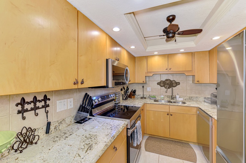 Your fully equipped kitchen awaits with granite countertops, stainless appliances, and everything you need to create memorable meals during your stay.