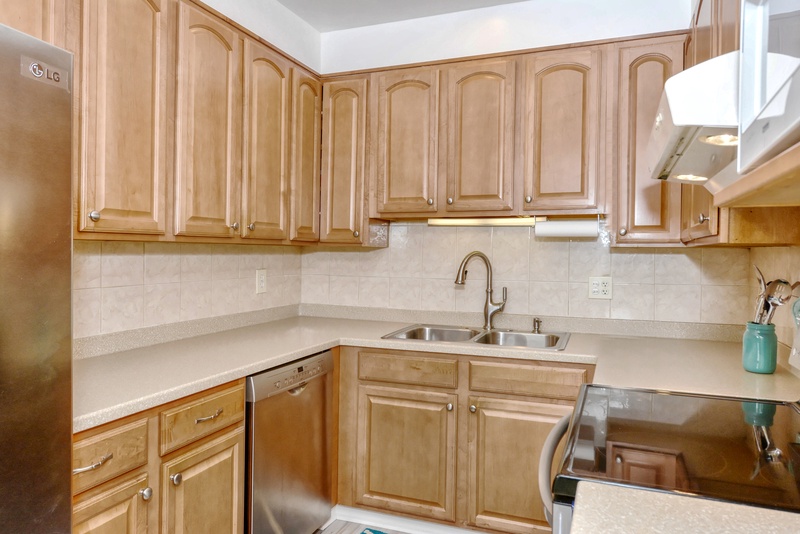 Your fully equipped kitchen features warm wood cabinets, ample counter space, and everything you need to prepare delicious meals during your stay.
