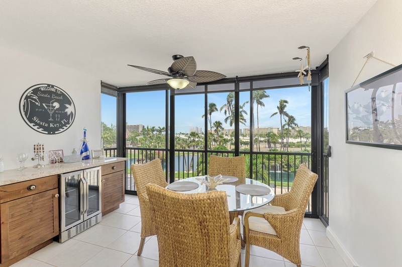 Savor meals in your tropical dining space with panoramic water views and swaying palm trees as your backdrop.