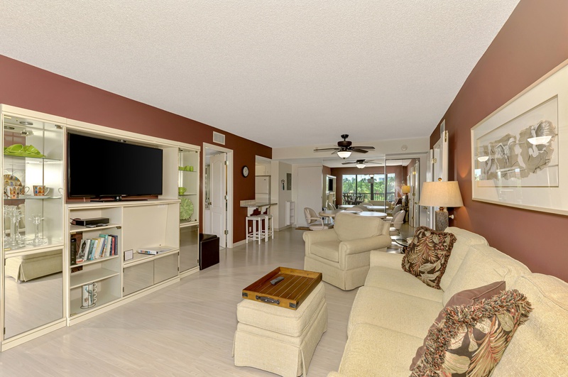 Unwind in your spacious living room with plush seating, entertainment center, and elegant décor creating the perfect atmosphere for relaxation.