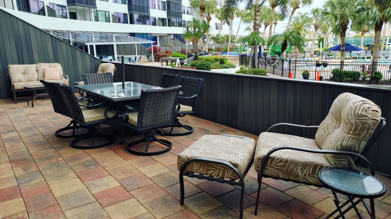 Your private patio features comfortable seating and dining areas where you can relax while enjoying views of the pool area.