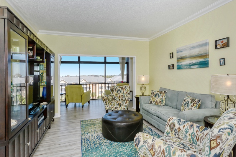 Unwind in your spacious living room with plush seating and stunning views through floor-to-ceiling windows.