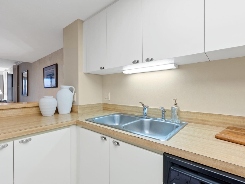 Your bright, modern kitchen features sleek white cabinets, warm wood countertops, and everything you need for home-cooked meals.