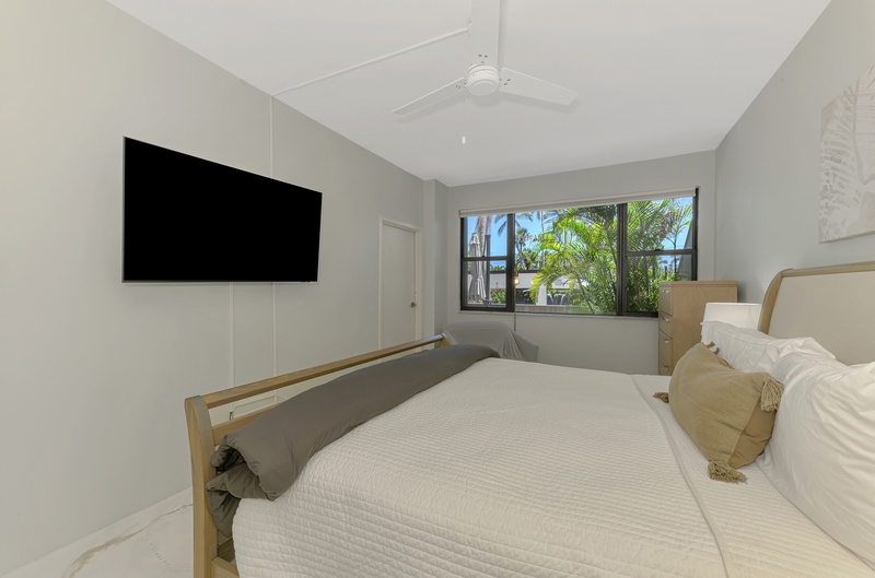 Drift off to sleep in your modern sanctuary with tropical views through the window and entertainment at your fingertips.