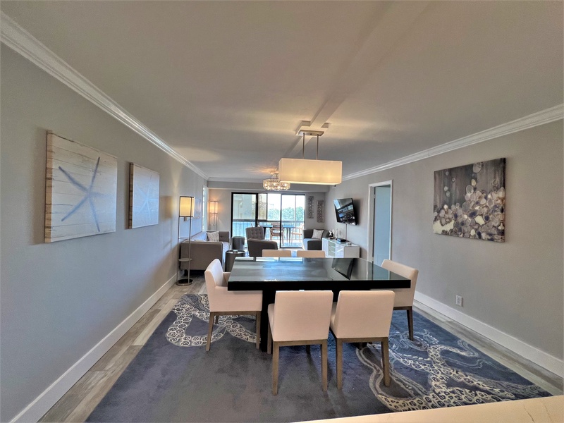 Unwind in your elegant dining space, featuring a sophisticated table for memorable meals and flowing into a comfortable living area perfect for relaxation.