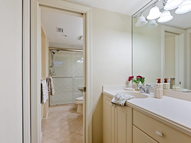 Your spacious bathroom features elegant dual vanities and a separate shower room, perfect for your morning routine.