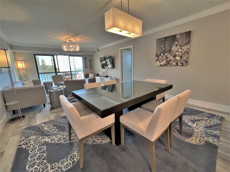 Gather around this sleek dining table where elegant lighting and modern comfort create the perfect setting for memorable meals together.