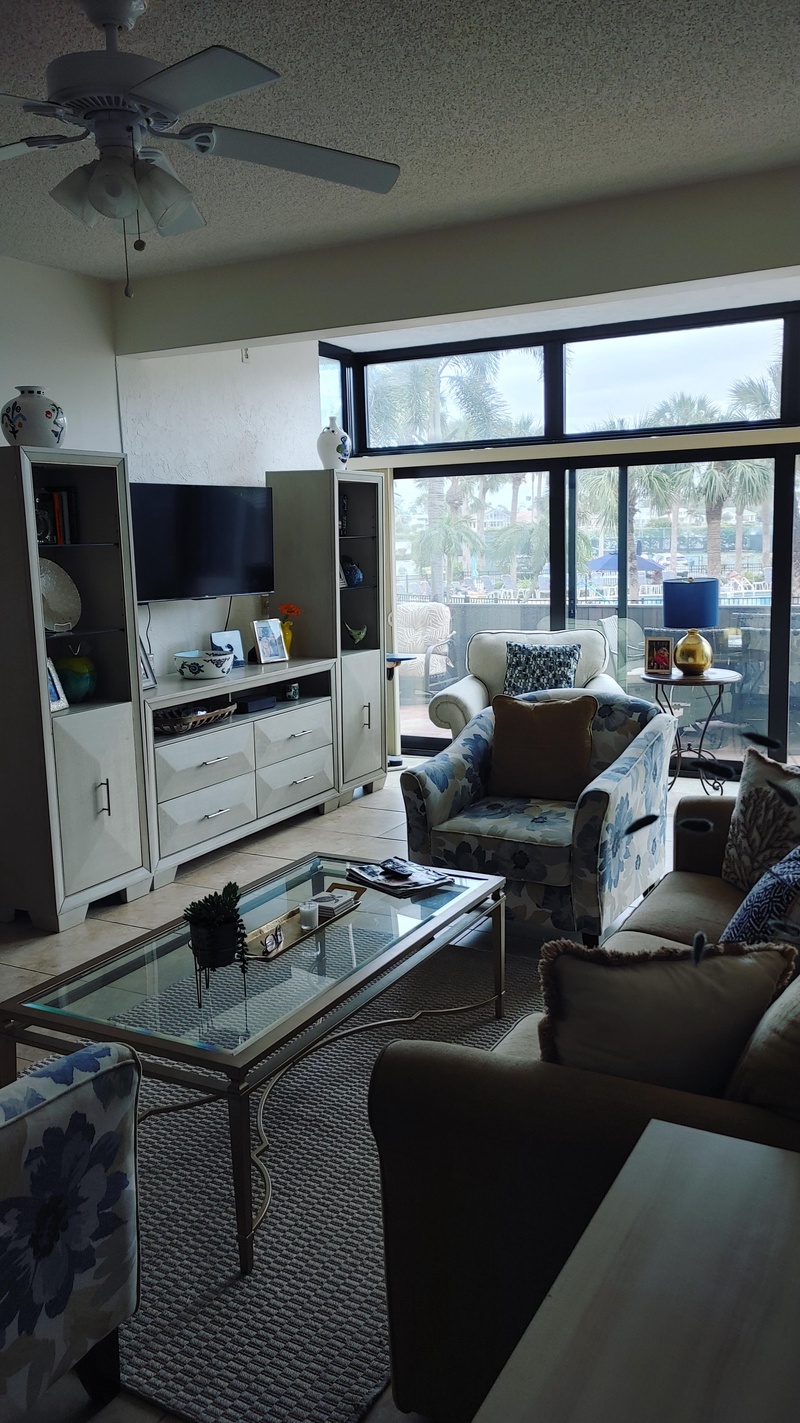 Relax in your comfortable living room with coastal views, entertainment center, and modern furnishings perfect for unwinding after exploring.