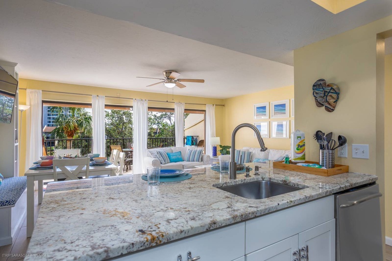Your spacious kitchen flows into the bright living area, where granite countertops and modern appliances make cooking a joy while staying connected to your guests.