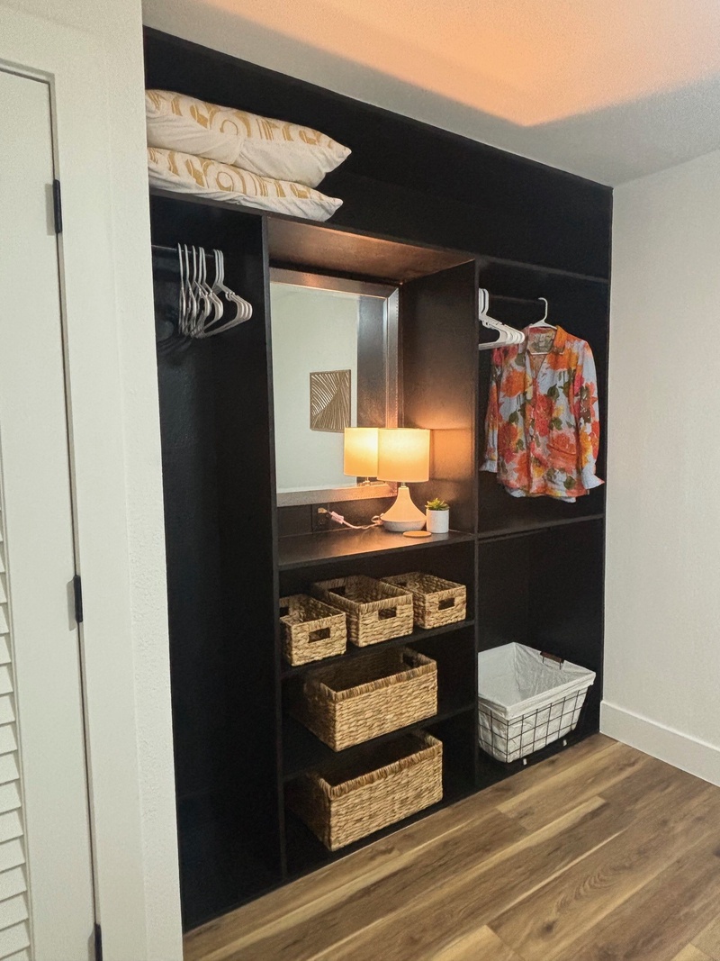 Your spacious walk-in closet features organized shelving, hanging rods, and wicker storage baskets to keep your belongings perfectly arranged.