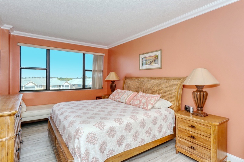 Drift off peacefully in your coral-toned bedroom, where warm natural light and cozy furnishings create the perfect retreat for restful nights.