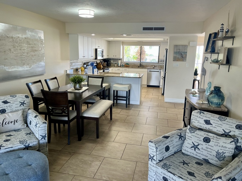 Relax in this bright, coastal-themed space where your fully-equipped kitchen flows seamlessly into comfortable living and dining areas.
