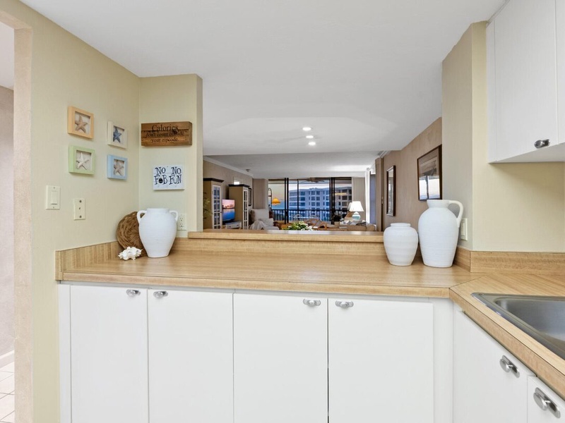 Cook with ease in your bright kitchen featuring warm wood countertops and thoughtful coastal touches that make meal prep a joy.