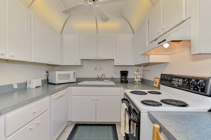 Your fully equipped kitchen awaits with everything you need to prepare meals during your stay, featuring modern appliances and ample counter space.