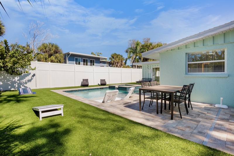 Your private backyard oasis features a sparkling pool, outdoor dining