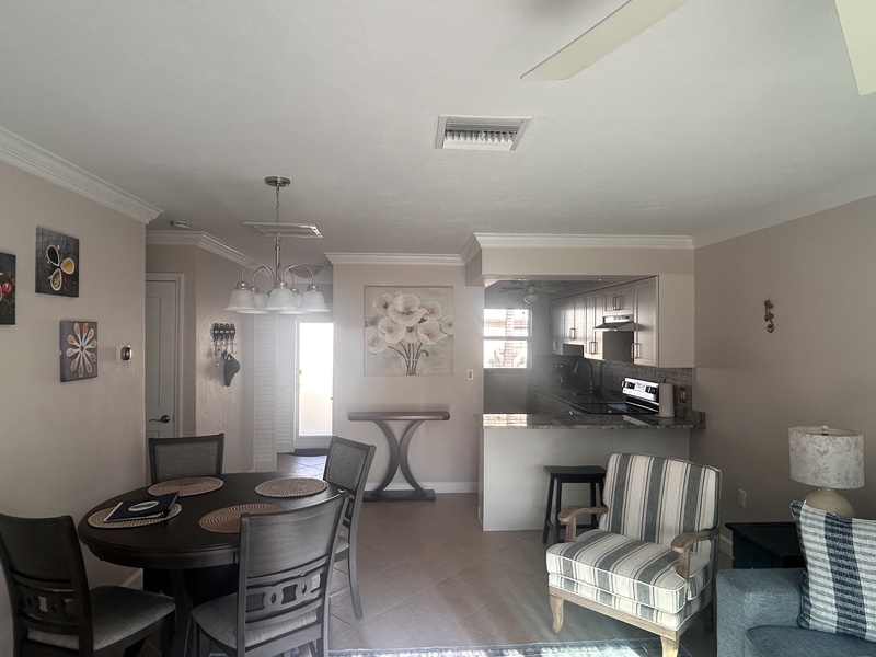 Your open-concept space seamlessly blends kitchen, dining, and living areas with modern finishes and thoughtful décor for comfortable gathering.