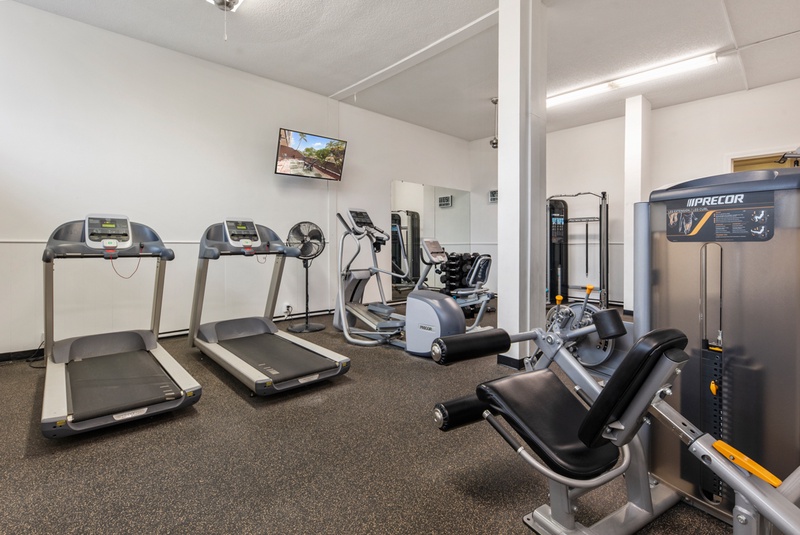 Stay active during your getaway in this well-equipped fitness center featuring treadmills, ellipticals, and strength training equipment for your daily workout routine.