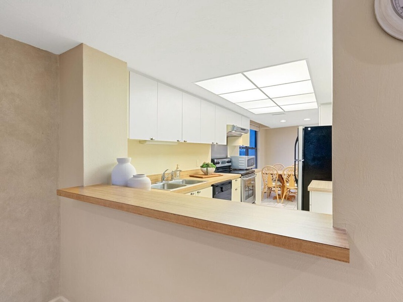 Your fully equipped kitchen opens to the dining area, creating a bright, welcoming space for cooking and gathering.