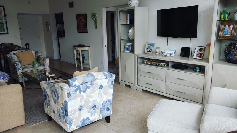 Relax in your bright, comfortable living room with coastal-inspired furniture, large flat-screen TV, and thoughtful touches throughout.