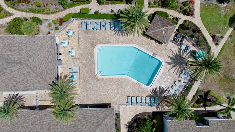 Shared heated pool with lounge chairs