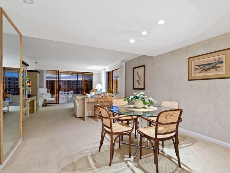 Your elegant dining space flows into the living area, with warm lighting and city views creating the perfect atmosphere for memorable meals.