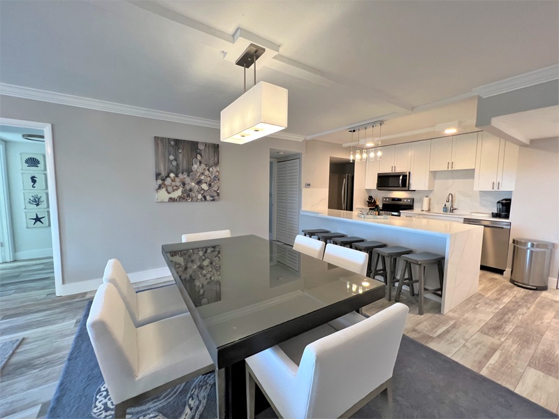 Step into your stylish open-concept space where the modern kitchen flows seamlessly into the dining area, creating the perfect setting for memorable meals.