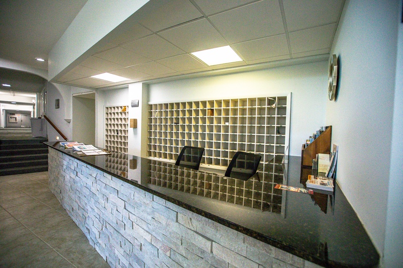 Modern reception desk with organized mail sorting system ensures smooth check-in and seamless communication throughout your stay.