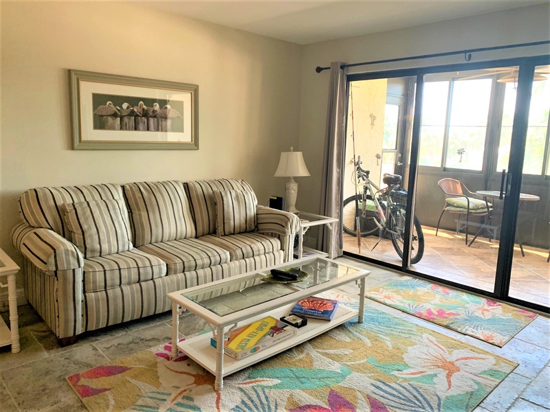 Sink into your comfortable striped sofa and enjoy coastal decor that captures the beach vibe, with sliding doors opening to your private balcony.