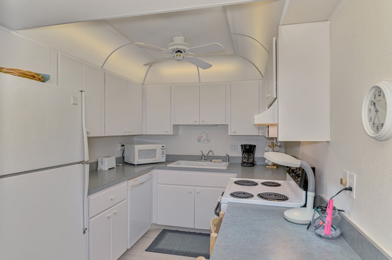 Your bright, fully-equipped kitchen awaits with all essentials for preparing meals during your stay.