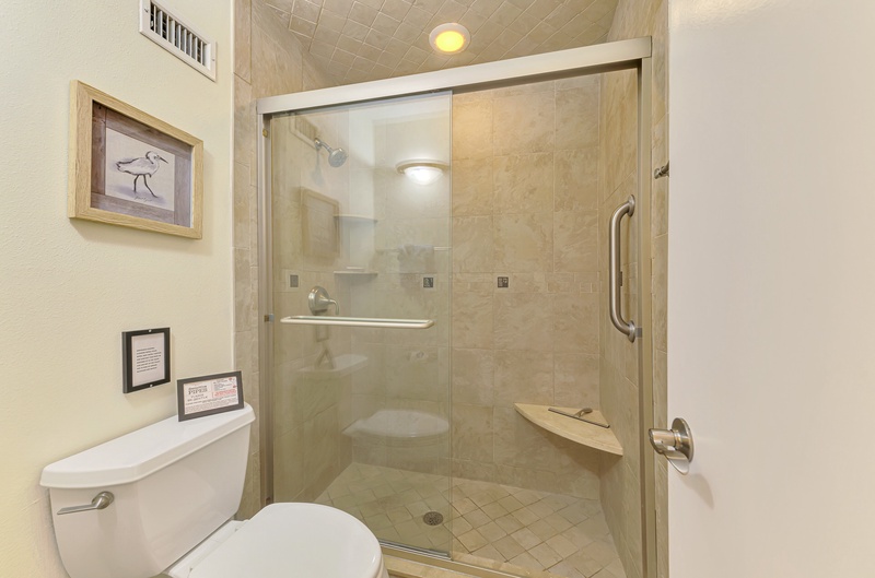Your private bathroom features a spacious walk-in shower with glass doors, perfect for refreshing after your adventures.