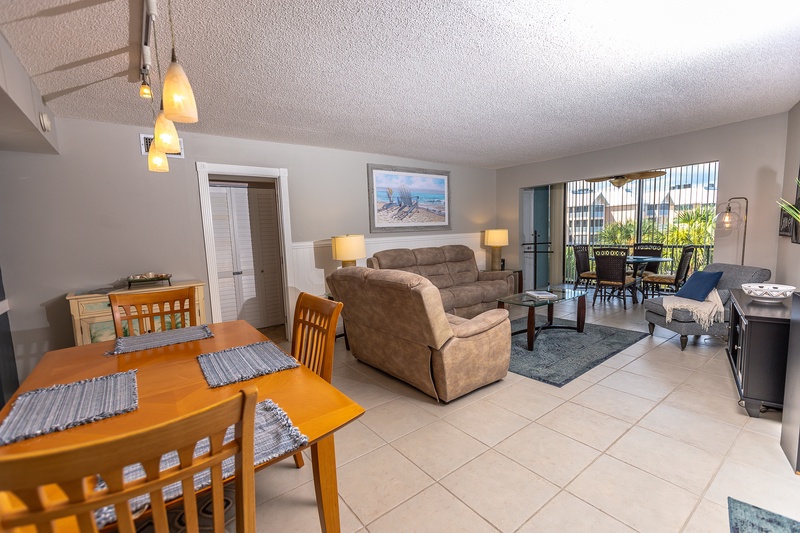 Unwind in your spacious living area featuring comfortable seating, warm lighting, and a dining space that opens to your private balcony.