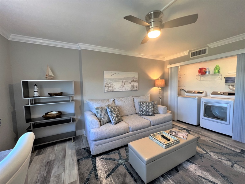 Relax on the plush sofa in your thoughtfully designed living space, with coastal decor and convenient laundry access.