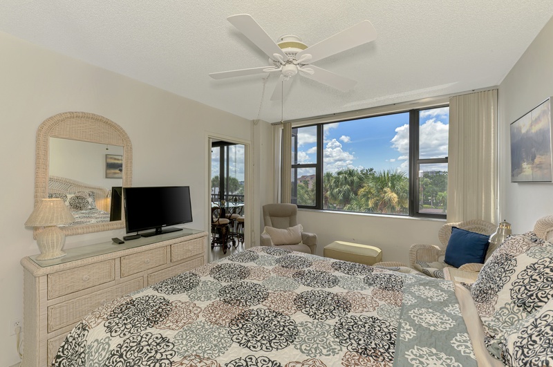 Relax in your coastal bedroom with palm tree views and gentle ceiling fan breezes keeping you comfortable year-round.