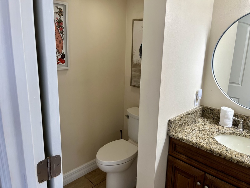 Your private bathroom features granite counters, stylish vanity, and separate toilet area for comfortable convenience during your stay.