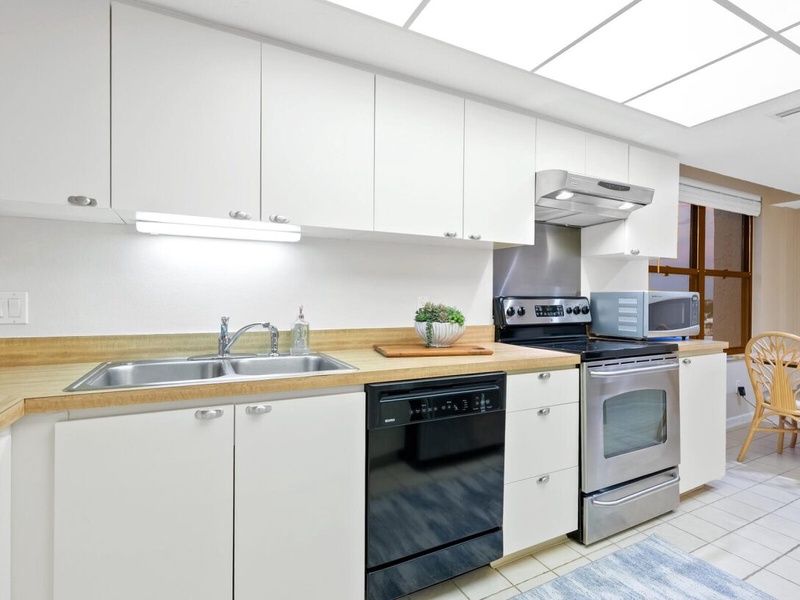 Bright modern kitchen with full appliances where you can prepare delicious meals under the beautiful skylight.