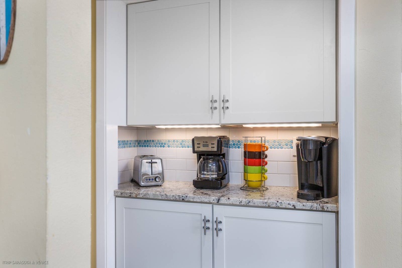 Start your mornings right with this convenient coffee station featuring fresh brewing options and cheerful colorful mugs ready for your perfect cup.