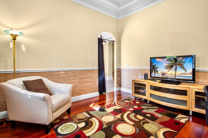 Private office with elegant plush seating and TV