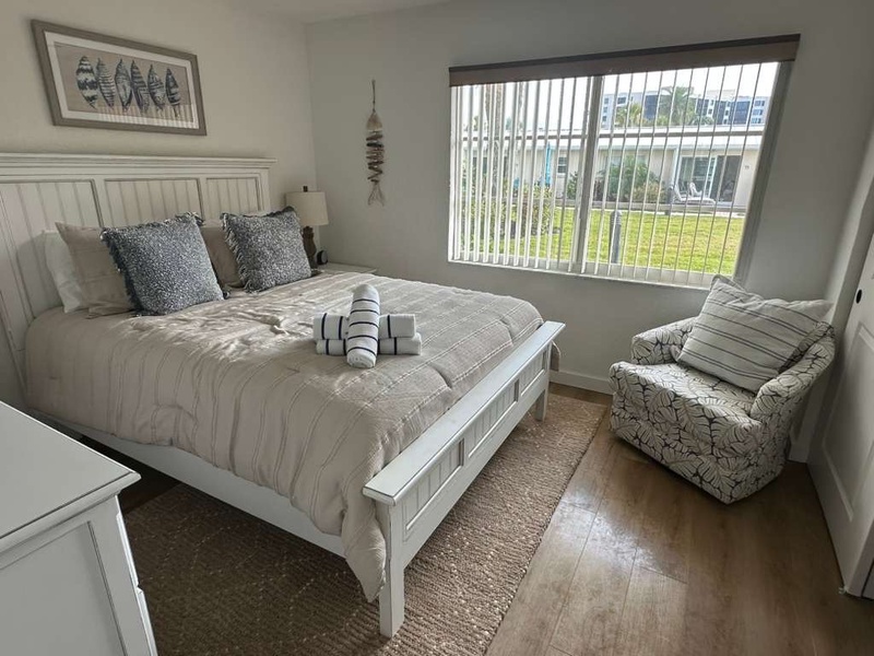 Sink into the plush bed with fresh linens and enjoy peaceful moments in your cozy reading chair by the bright window.