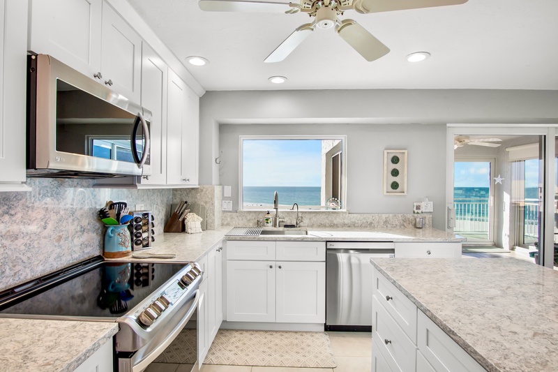 Cook with stunning ocean views through your kitchen window, where marble countertops and modern appliances make meal prep a joy.