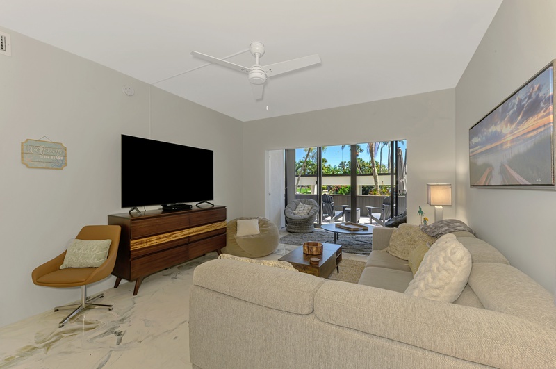 Sink into plush seating while enjoying your favorite shows on the large TV, with tropical views beckoning from your private balcony.