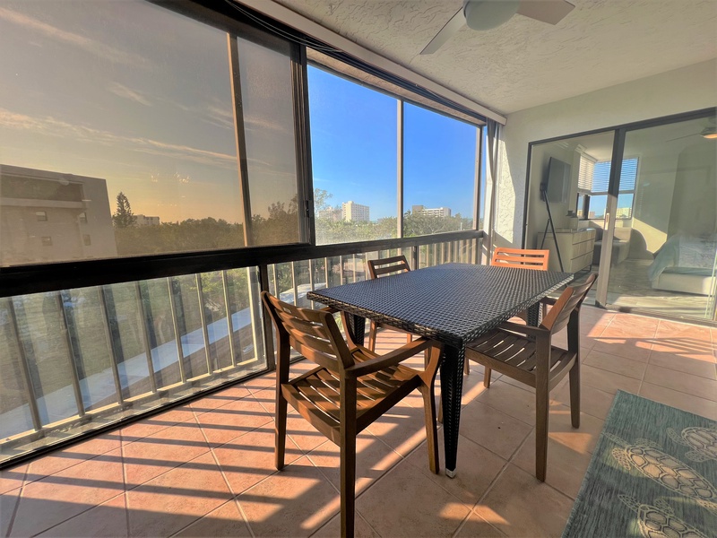 Your private balcony dining space features panoramic city views through floor-to-ceiling windows, perfect for morning coffee or evening meals.