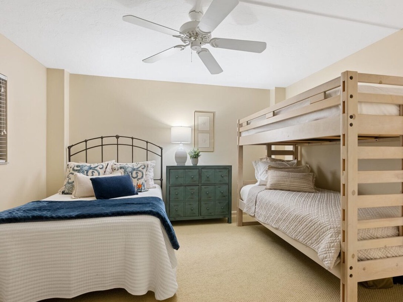 Unwind in your spacious bedroom with comfortable beds and a ceiling fan to keep you cool during warm evenings.