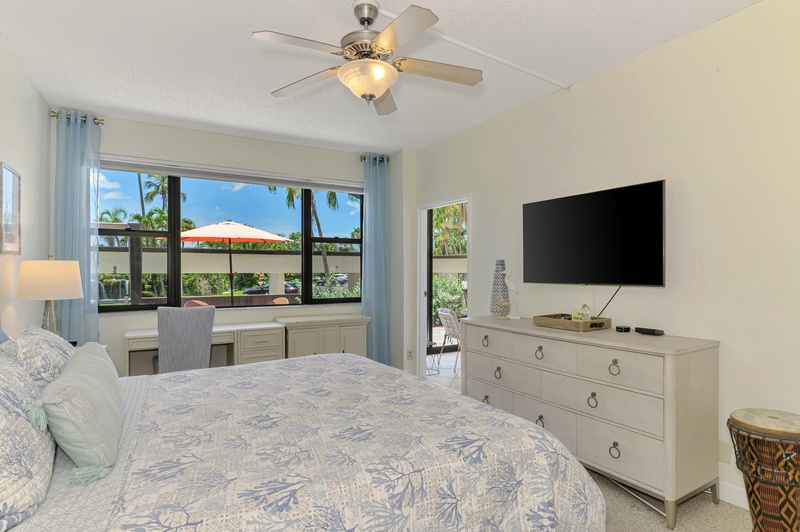 Relax in your serene bedroom featuring tropical views, modern amenities, and comfortable furnishings for the perfect getaway retreat.