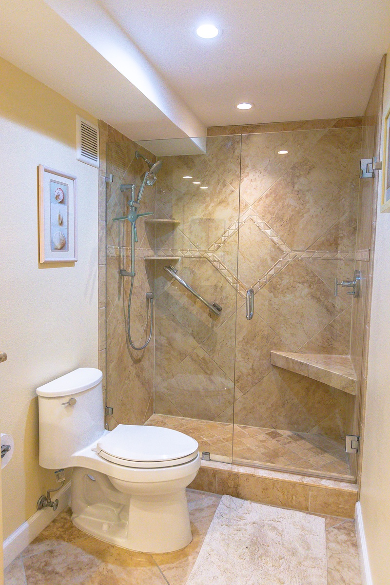Step into your beautifully appointed bathroom featuring a luxurious walk-in shower with elegant stone tilework and modern fixtures.