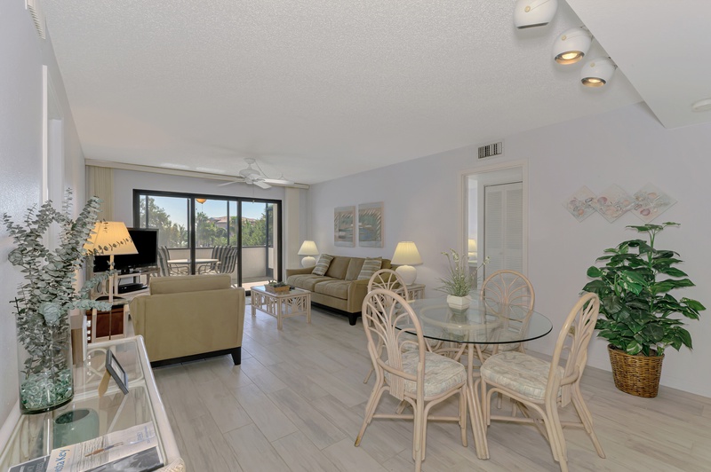 Relax in your bright, airy living space with coastal furnishings and tropical plants that create a serene atmosphere for your getaway.