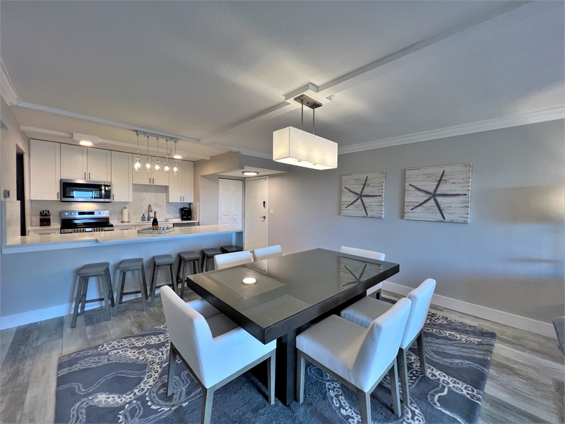 Your open-concept space flows beautifully from kitchen to dining, with sleek granite counters and elegant lighting creating the perfect gathering spot.