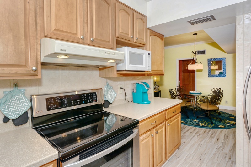Your fully equipped kitchen awaits with warm wood cabinets, modern appliances, and everything you need to create delicious meals during your stay.